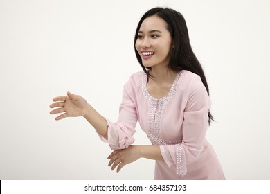 malay woman with baju kurung  greeting on the white background