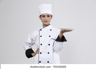 Malay Woman Chef  Holding A Plate With Hand Gesture