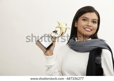 malay woman holding a star trophy on the white background