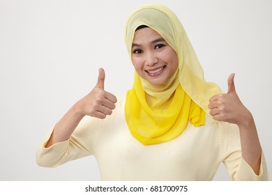 Malay woman with scarf showing thumbs up