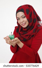 Malay Woman With Tudung Carefully Holding A Pelita