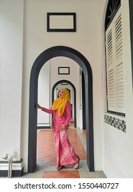 A Malay Woman Wearing Traditional Kebaya Nyonya Costume At Old Building Malacca, Malaysia