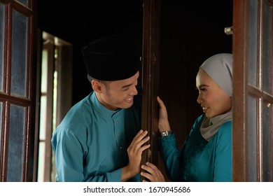 Malay Young Couple At The Wooden Window Of A Traditional Malay House