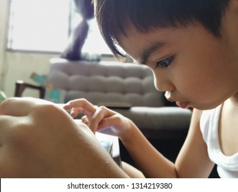 Malaysia - Circa January 2019 : Kid Playing And Watching Youtube Using  Smart Phone Or Tablet.