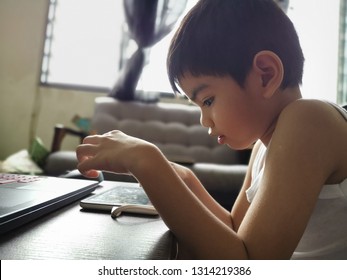 Malaysia - Circa January 2019 : Kid Playing And Watching Youtube Using  Smart Phone Or Tablet.