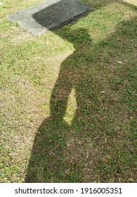 Malaysia. February 2021. A human shadow on the grass. 