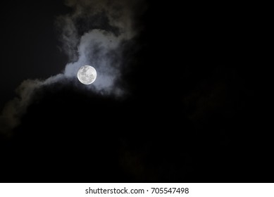 MALAYSIA - FEBRUARY 5, 2015: Moon Behind The Clouds. This Photo Was Taken During A Dark Cloudy Night Sky With Bright Full Moon Behind Them.