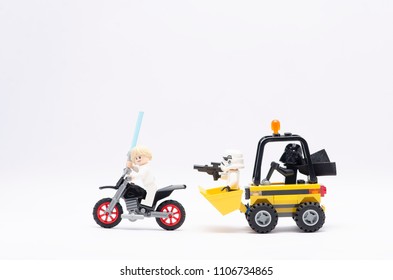 MALAYSIA, may 21, 2018. mini figure of darth vader driving wheel loader with storm trooper chasing luke skywalker riding motorcycle. Lego minifigures are manufactured by The Lego Group.