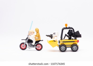 MALAYSIA, may 21, 2018. mini figure of darth vader driving wheel loader with storm trooper chasing luke skywalker and c3po riding motorcycle. Lego minifigures are manufactured by The Lego Group.