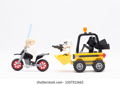 MALAYSIA, may 21, 2018. mini figure of darth vader driving wheel loader with storm trooper chasing luke skywalker riding motorcycle. Lego minifigures are manufactured by The Lego Group.