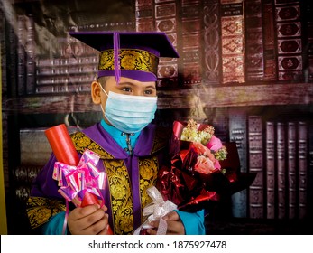 MALAYSIA-DECEMBER 16,2020. Pre School Student At Bandar Behrang Primary School, Perak. A 6 Years Old Boy Wear A Face Mask During Covid 19 Pandemic For A Pre School Graduation Photo Shoot Session. 