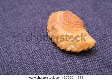 Malaysian favourite snack, curry puff on a fabric tecture