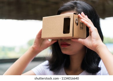 Malaysian Girl Wearing VR Cardboard Helmet