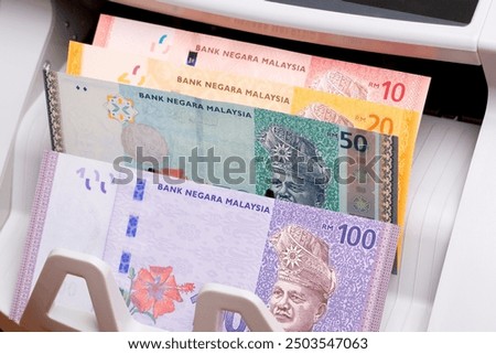 Malaysian  money - ringgit in the counting machine