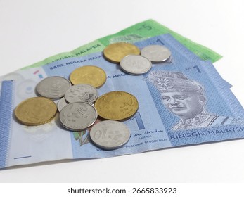Malaysian Ringgit bank notes with some ringgit coins, financial concept photo