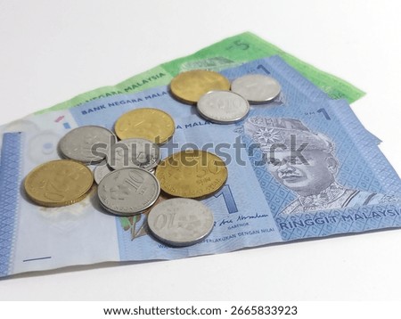 Malaysian Ringgit bank notes with some ringgit coins, financial concept photo