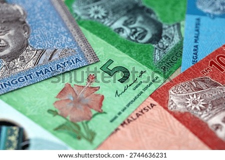 Malaysian ringgit paper banknotes pile on table. Malaysia MYR currency money bills in big amount. Concept of economics, taxation and banking in Malaysia