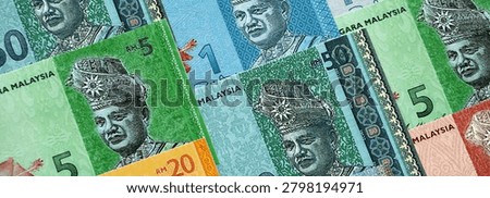 Malaysian ringgit paper banknotes pile on table. Malaysia MYR currency money bills in big amount. Concept of economics, taxation and banking in Malaysia
