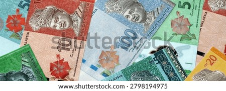 Malaysian ringgit paper banknotes pile on table. Malaysia MYR currency money bills in big amount. Concept of economics, taxation and banking in Malaysia