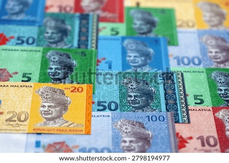 Malaysian ringgit paper banknotes pile on table. Malaysia MYR currency money bills in big amount. Concept of economics, taxation and banking in Malaysia