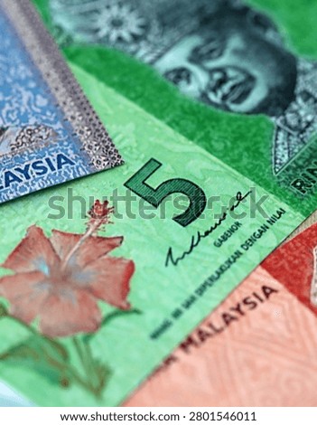 Malaysian ringgit paper banknotes pile on table. Malaysia MYR currency money bills in big amount. Concept of economics, taxation and banking in Malaysia