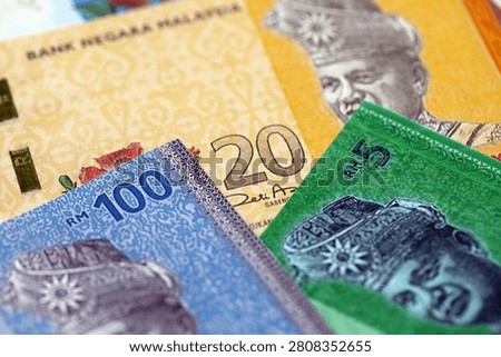 Malaysian ringgit paper banknotes pile on table. Malaysia MYR currency money bills in big amount. Concept of economics, taxation and banking in Malaysia