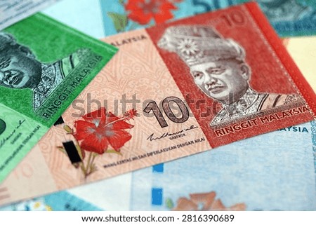 Malaysian ringgit paper banknotes pile on table. Malaysia MYR currency money bills in big amount. Concept of economics, taxation and banking in Malaysia
