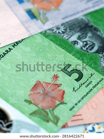 Malaysian ringgit paper banknotes pile on table. Malaysia MYR currency money bills in big amount. Concept of economics, taxation and banking in Malaysia