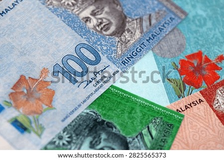 Malaysian ringgit paper banknotes pile on table. Malaysia MYR currency money bills in big amount. Concept of economics, taxation and banking in Malaysia