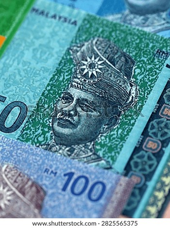 Malaysian ringgit paper banknotes pile on table. Malaysia MYR currency money bills in big amount. Concept of economics, taxation and banking in Malaysia