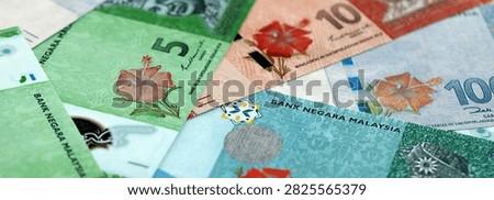 Malaysian ringgit paper banknotes pile on table. Malaysia MYR currency money bills in big amount. Concept of economics, taxation and banking in Malaysia