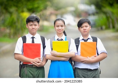 Malaysian Students Holding Book While Carrying Stock Photo 2041225385 ...