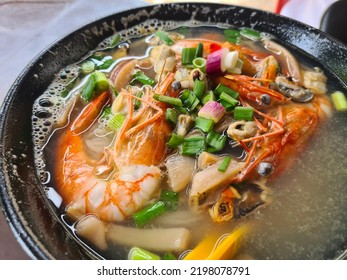 Malaysian Style Seafood With Prawn, Squid, Fish, Clams Noodles. Famous Malaysian Food With Fresh Cooked Seafood Soup Chinese Style Soup. Asian Cuisine.