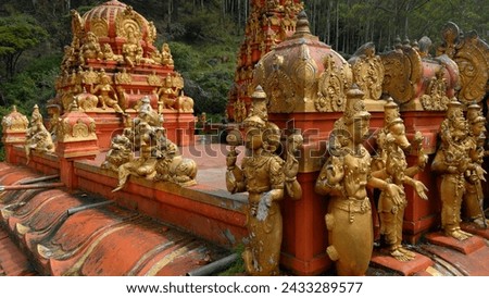 Malaysian temple with golden statues of the saints. Action. Concept of religion and culture.