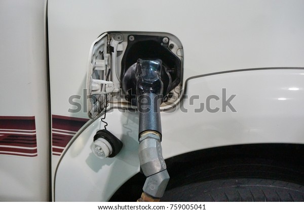 Malaysia-Nov 20, 2017: A car fueling at Petronas\
petrol pump. From 2014, Malaysia fuel prices will be floated to\
International price. Fuel price will be revealed at every wednesday\
of the week.