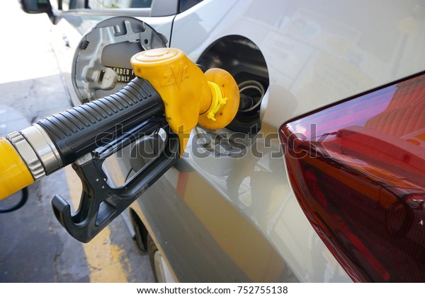 Malaysia-Nov\
5, 2017: A car fueling at Petronas petrol pump. From 2014, Malaysia\
fuel prices will be floated to International price. Fuel price will\
be revealed at every wednesday of the\
week.