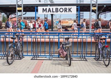 Malbork, Poland, May 2016: School Class On The Platform At Malbork Railway Station With Bike Rack In The Foreground