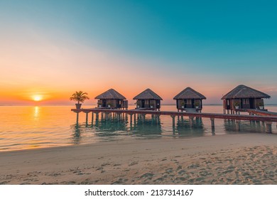 Maldives island sunset. Water bungalows resort at islands beach. Indian Ocean, Maldives. Beautiful sunset landscape, luxury resort villas and colorful sky. Summer vacation holiday and travel concept - Shutterstock ID 2137314167