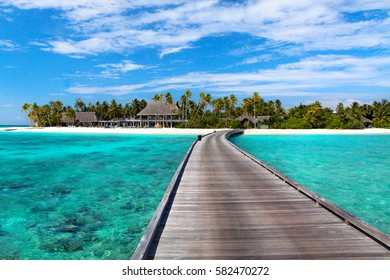 Maldives resort bridge.Exotic landscape with palms and blue lagoon. Tropical background. - Powered by Shutterstock