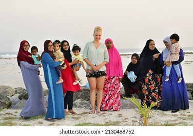 MALDIVES – THULUSDHOO – JANUARY 2020 - Czech Traveller Lenka Kopalova Posing With A Triplets Women And Large Maldivian Family Watching The Sunset On The Island.