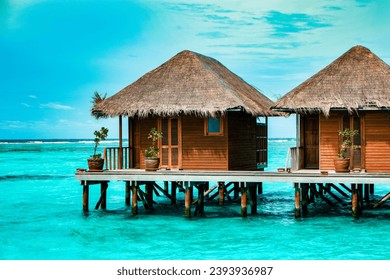 Maldives tropical Island, beautiful isolated luxury water bungalows Maldives in the blue green ocean of the Maldives Island, turqouse colored ocean 