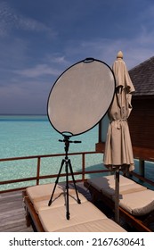 Maldives.Working with a solar reflector for photography on a tripod on the terrace of a luxury room in the Maldives. Photo reflector.