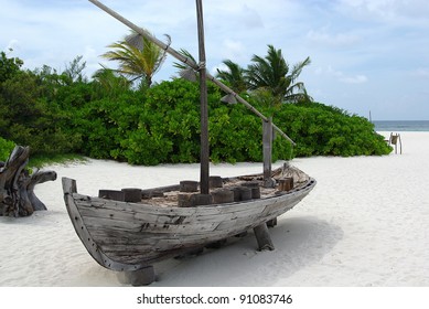 Maldivian boat on a white sand beach