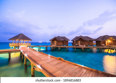 Maldivian water bungalows at night