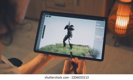 Male 3D designer creating 3D animation of video game character in design application on modern digital tablet computer using stylus - Shutterstock ID 2206033113