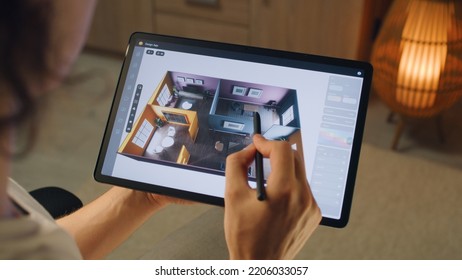 Male 3D designer using digital tablet computer and pencil and creating interior of house in professional design application while working on project remotely - Powered by Shutterstock