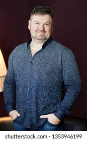 Male 40-45 Years Old With A Beard On His Face In A Shirt On A Dark Background.