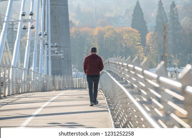 Male adult person is walking on the metal bridge. - Powered by Shutterstock