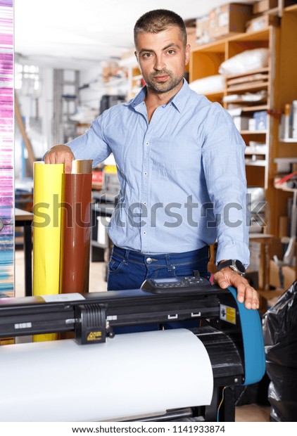 male\
advertising agency worker with adhesive films\
print