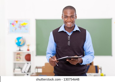 male African school teacher holding a clipboard